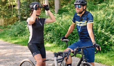 Ein Paar macht eine Pause beim Fahrradfahren im Wald.