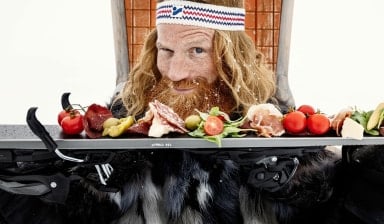 Der Winter im Schnee hält einen Ski mit Antipasti.