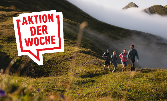 Aktion der Woche: Eine Gruppe von Menschen beim Wandern in den Bergen. Im Tal hängt noch der Nebel.