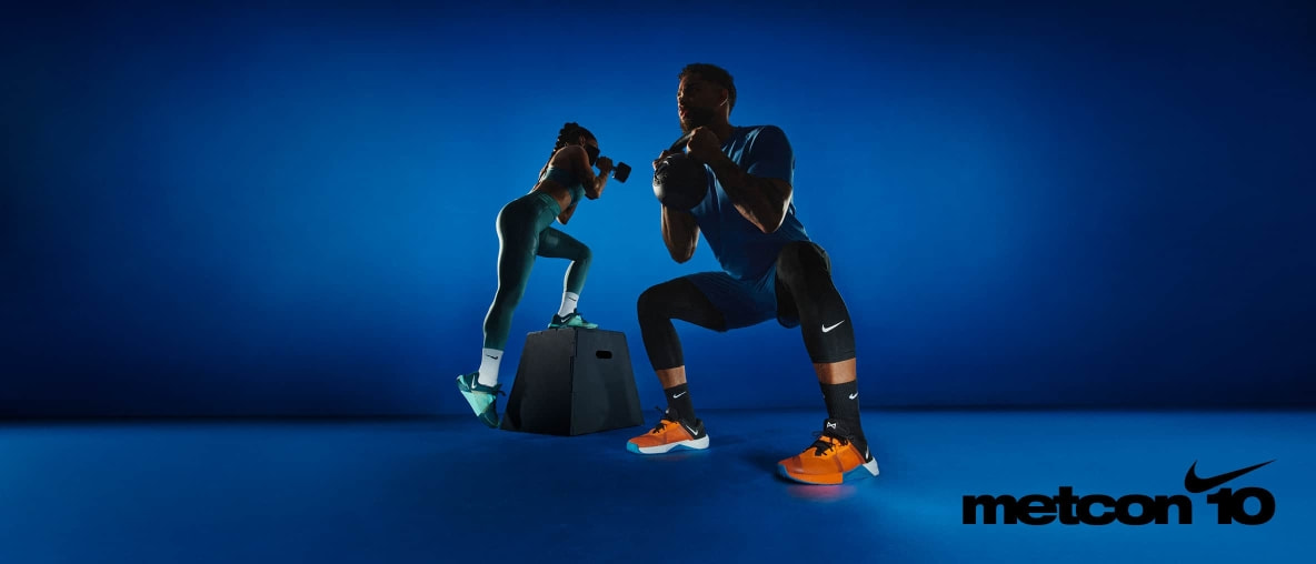 Zwei Sportler trainieren intensiv in stylischer Studio-Atmosphäre – im Fokus: der Nike Metcon 10 Trainingsschuh.