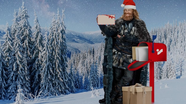 Der Winter steht neben einem Briefkasten und hält einen Brief in die Höhe – INTERSPORT Weihnachtswunschzettel.