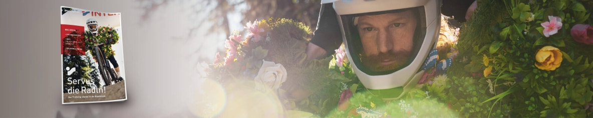 Der Frühling macht sich bereit für ein Bike-Rennen. Im Vordergrund die Titelseite des INTERSPORT Bike-Special.