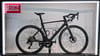 Schwarzes Rennrad mit Carbonrahmen und Scheibenbremsen.