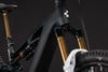 Detail eines Mountainbike-E-Bikes mit Federung und goldenen Gabeln.