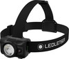 Eine schwarze Ledlenser-Stirnlampe mit verstellbarem Gurt und hellem Licht.