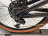 Schaltwerk und Kassette an einem schwarzen Fahrrad mit braunem Reifen.