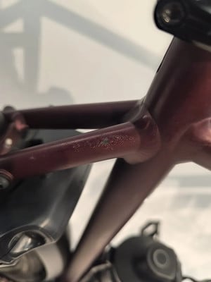 Am Fahrradrahmen sind kleine Kratzer und Farbabplatzungen sichtbar. Am Fahrradrahmen sind kleine Kratzer und Farbabplatzungen sichtbar.