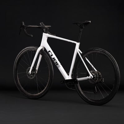 Ein weißes Cube Rennrad mit schwarzen Rädern und Details. Ein weißes Cube Rennrad mit schwarzen Rädern und Details.