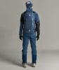 Rückansicht eines Mannes in blauer Skibekleidung mit Rucksack.