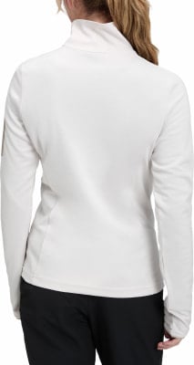 Rückansicht einer Frau in einer weißen Langarmjacke und schwarzer Hose. Rückansicht einer Frau in einer weißen Langarmjacke und schwarzer Hose.