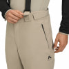 Beige Skihose mit schwarzen Hosenträgern und Reißverschlusstasche.