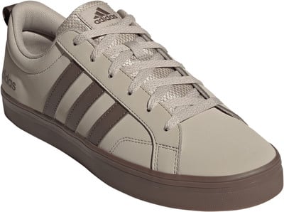 Beige Adidas Sneaker mit braunen Streifen und Gummisohle. Beige Adidas Sneaker mit braunen Streifen und Gummisohle.