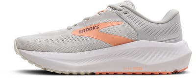 Grauer Laufschuh mit orangefarbenem Brooks-Logo und weißer Sohle. Grauer Laufschuh mit orangefarbenem Brooks-Logo und weißer Sohle.