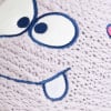 Detail einer Strickoberfläche mit einem gestickten Gesicht und blauen Konturen.