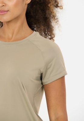 Detail eines kurzärmeligen Damen-T-Shirts in Beige. Detail eines kurzärmeligen Damen-T-Shirts in Beige.