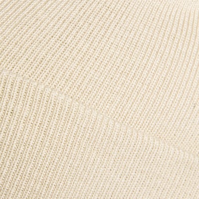Beiger Strickstoff mit feinem Rippenmuster. Beiger Strickstoff mit feinem Rippenmuster.