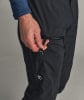 Eine Männerhand hält eine Schlaufe am Reißverschluss einer schwarzen Hose.