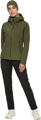 Eine Frau in einer grünen Jacke und schwarzen Hose mit einer Mütze. Eine Frau in einer grünen Jacke und schwarzen Hose mit einer Mütze.