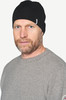 Mann mit schwarzer Mütze und grauem Pullover mit Schnurrbart.