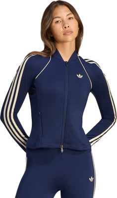 Dunkelblaue Adidas Jacke für Damen mit beigen Streifen und Logo. Dunkelblaue Adidas Jacke für Damen mit beigen Streifen und Logo.