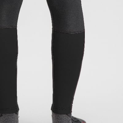 Detail von Hosen mit unterschiedlichen Materialien und gemusterten Socken.