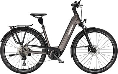 Graues KTM E-Bike mit Gepäckträger und Schutzblechen vor weißem Hintergrund. Graues KTM E-Bike mit Gepäckträger und Schutzblechen vor weißem Hintergrund.