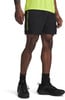 Mann in schwarzer Hose mit Neonaufdruck und gelbem Shirt.