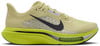 Sárga Nike futócipő sötétkék Swoosh-sal és zöld talppal.