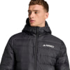 Ein Mann in einer schwarzen Daunenjacke mit Terrex-Logo auf der Brust.