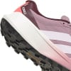 Detail der Sohle und Seite eines rosa Adidas Terrex Laufschuhs mit weißem Streifen.