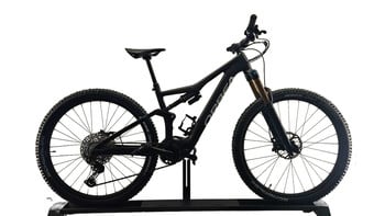 Schwarzes Orbea E-Mountainbike auf weißem Hintergrund, auf einem Ständer.