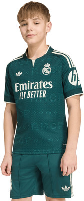 Junge in dunkelgrünem Real Madrid Fußballtrikot mit Adidas- und Emirates-Logo. Junge in dunkelgrünem Real Madrid Fußballtrikot mit Adidas- und Emirates-Logo.