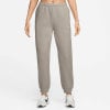 Graue Nike Jogginghose für Damen mit Logo am Oberschenkel und weißen Sneakern.