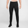 Schwarze Nike Sporthose mit rotem Logo und Schuhen.