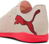 Cremefarbene Puma Fußballschuhe mit rosa Logo und Sohle.
