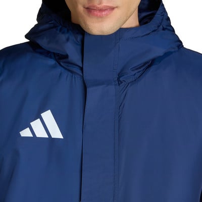 Ein Mann trägt eine dunkelblaue Kapuzenjacke mit weißem Adidas-Logo.