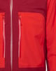Eine rote Jacke mit zwei Reißverschlüssen und seitlichen Taschen.