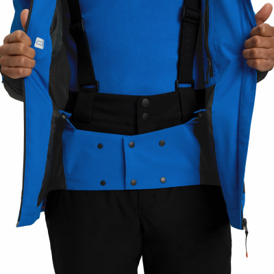 Blaue Skijacke mit schwarzer Latzhose und Reißverschlussdetails. Blaue Skijacke mit schwarzer Latzhose und Reißverschlussdetails.