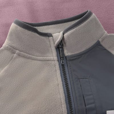 Detail einer Fleecejacke mit Reißverschluss und dunkelgrauem Einsatz. Detail einer Fleecejacke mit Reißverschluss und dunkelgrauem Einsatz.