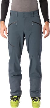Ein Mann in dunkelgrauer Skihose und gelben Skischuhen.