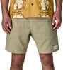 Mann in hellbraunen Cordshorts und gelbem Hemd mit Blumenmuster.