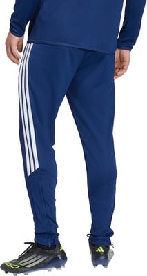 Blaue Adidas Trainingshose mit weißen Streifen und schwarzen Fußballschuhen.