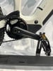 Detail eines E-Bikes: Kurbelgarnitur, Pedal und Rahmenteil mit Akku.