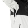 Detail einer Jacke mit schwarzen und weißen Blöcken, die eine Reißverschlusstasche freilegt.