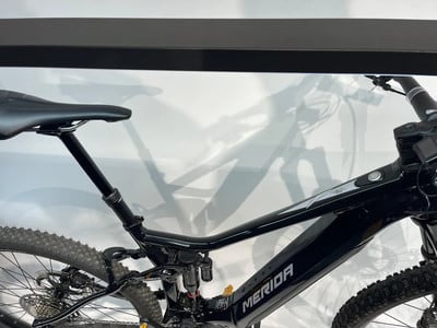 Detail des Rahmens eines schwarzen E-Mountainbikes mit Dämpfer und Sattel. Detail des Rahmens eines schwarzen E-Mountainbikes mit Dämpfer und Sattel.