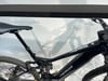 Detail des Rahmens eines schwarzen E-Mountainbikes mit Dämpfer und Sattel.