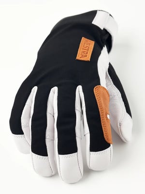 Eine schwarze und weiße Handschuh mit braunen Lederdetails und HESTRA-Logo. Eine schwarze und weiße Handschuh mit braunen Lederdetails und HESTRA-Logo.
