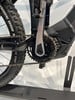 Detail eines E-Mountainbikes mit Kette und Kurbel auf weißem Hintergrund.