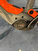 Detail eines E-Bikes mit Bosch Performance CX Motor und orangen Akzenten.