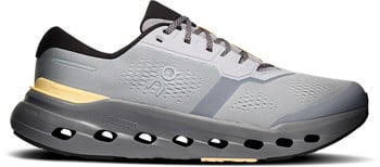 Grauer Laufschuh mit gelben und dunklen Details und atmungsaktivem Mesh.